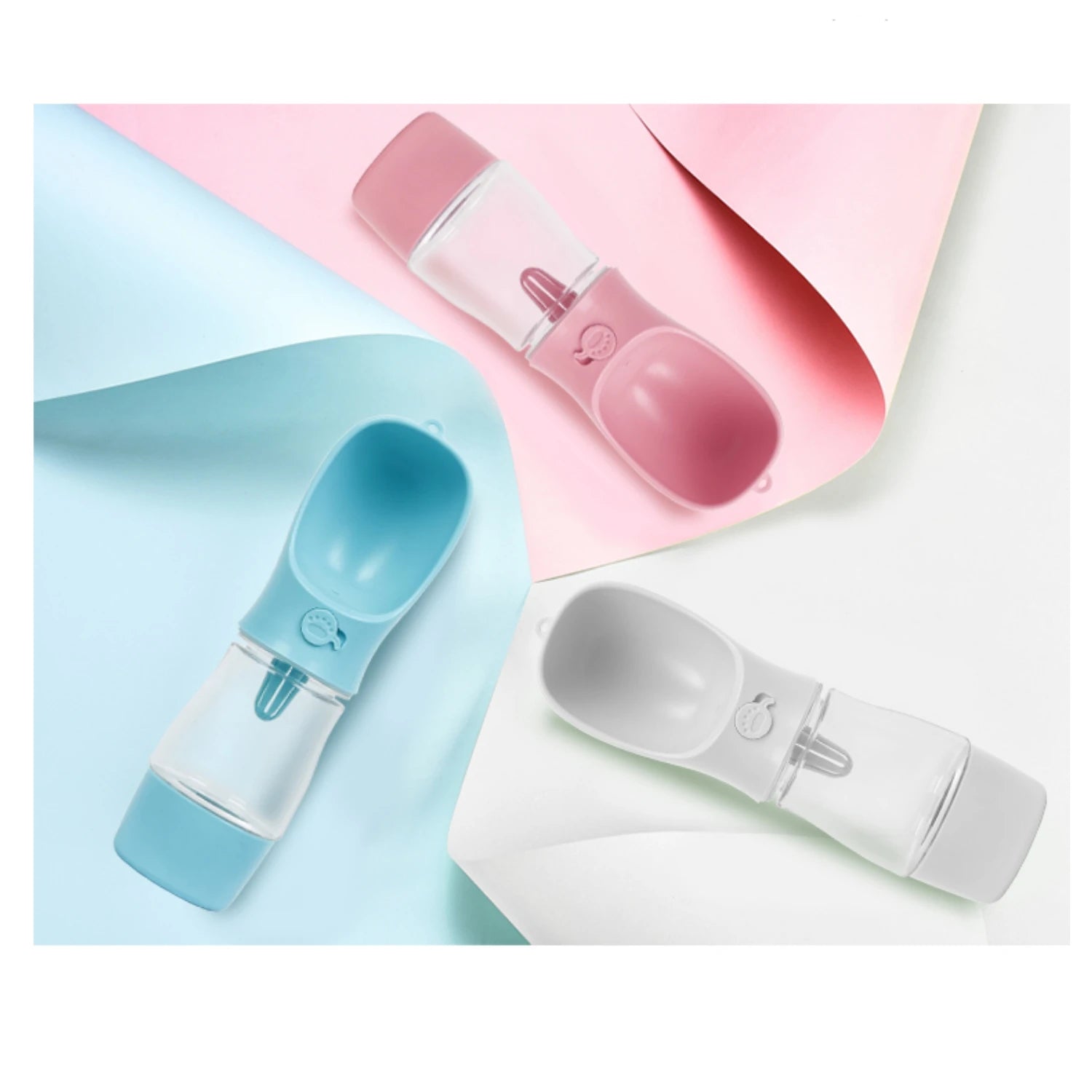 Three baby bottles with different colors on a colorful background