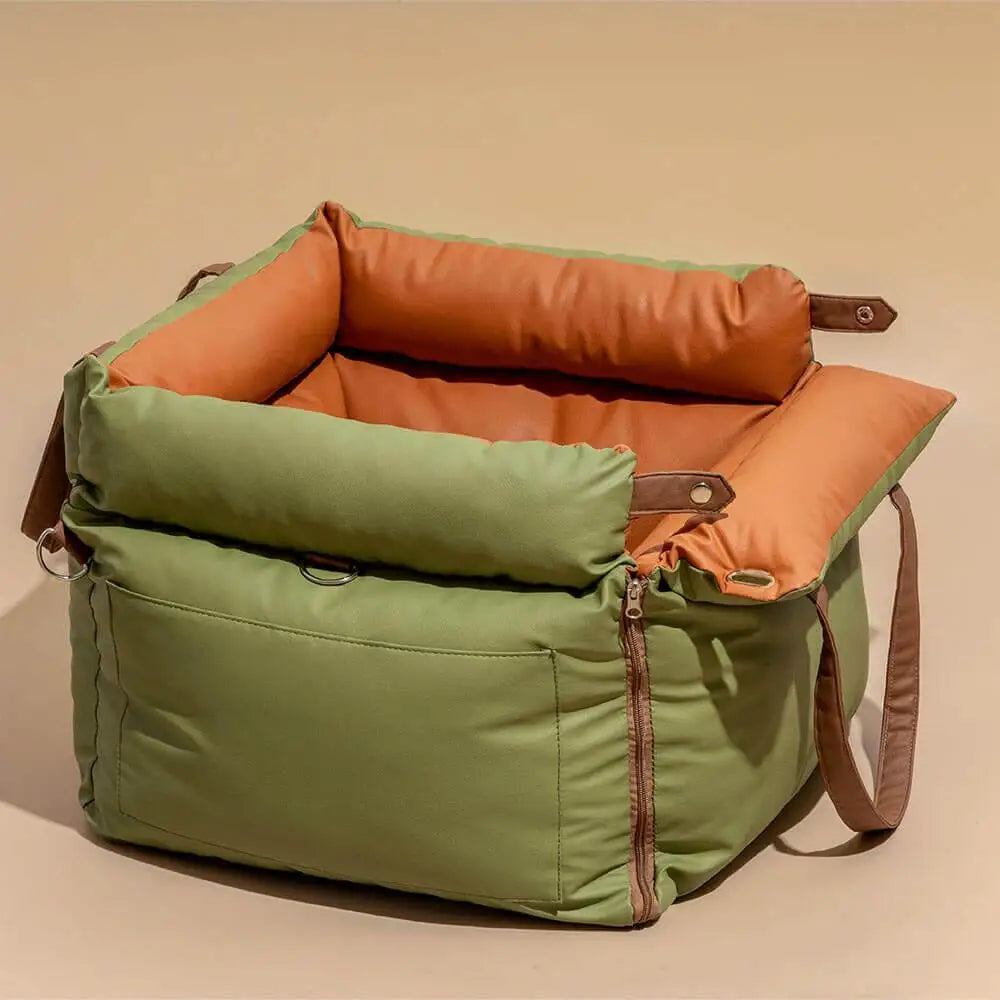 Green and brown pet carrier on a beige background