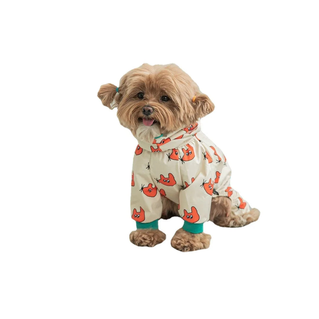 Small dog wearing a white onesie with orange fox patterns on a white background