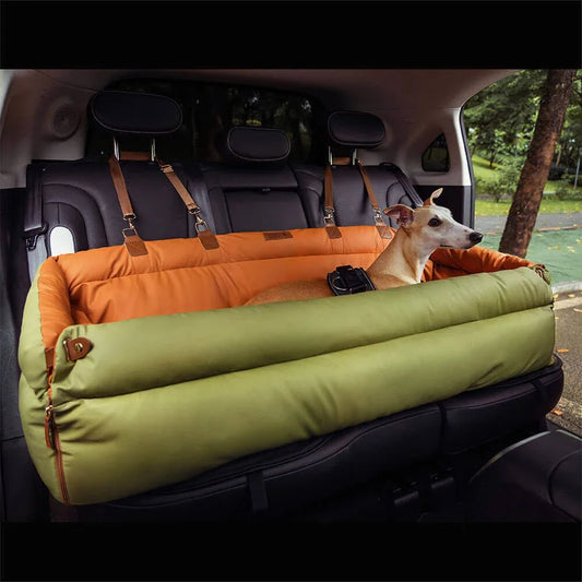 Dog lying on a green and orange pet pet travel bed in a car