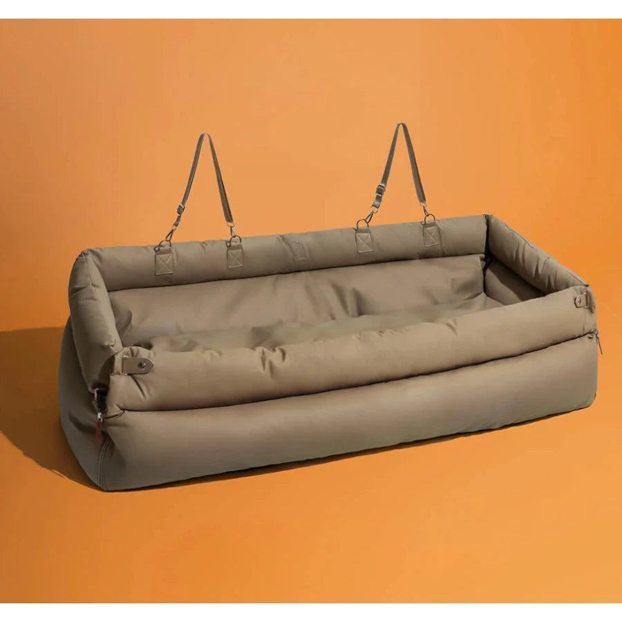 Dog travel bag and bed for cars with straps on an orange background